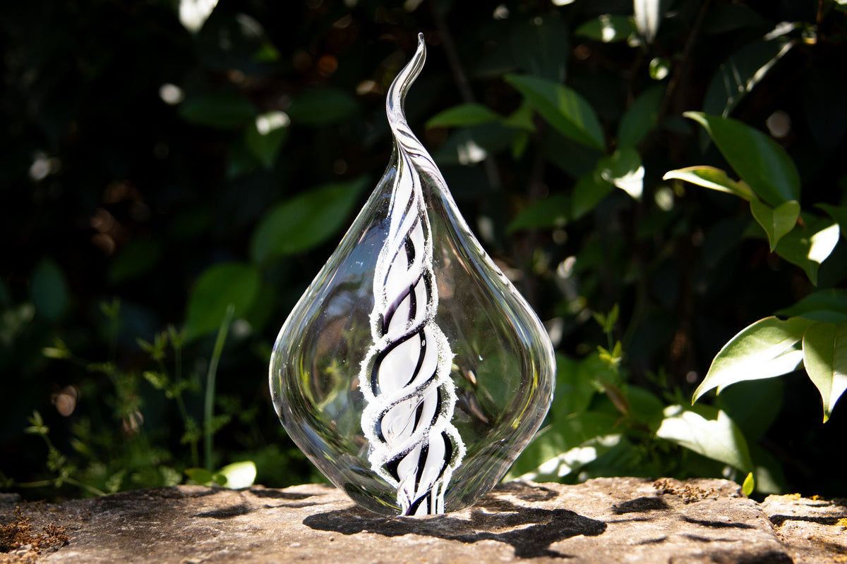 glass flame with cremation ash from pets and people